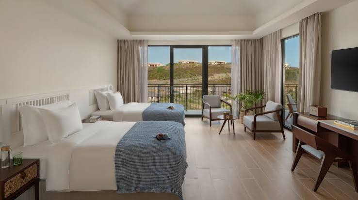 Bright hotel room opening onto a terrace